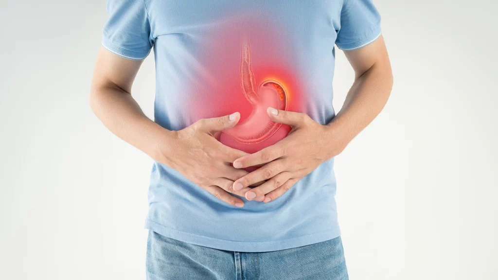 dr.consulta - Homem com as mãos na barriga, com ilustração do estômago em destaque e área avermelhada, representando dor ou inflamação, simbolizando o que é gastrite. 
